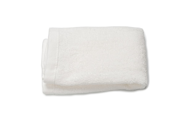 White fluffy cotton towel isolated on a white surface. Spa and resort.