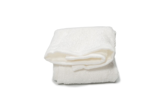 White fluffy cotton towel isolated on a white surface. Spa and resort.