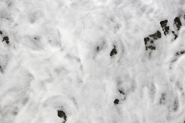 White foam bottom waves reaching shore overhead view