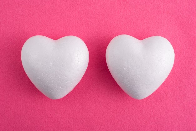 White foam heart on a red felt background