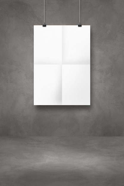 Photo white folded poster hanging on a dark concrete wall with clips. blank mockup template