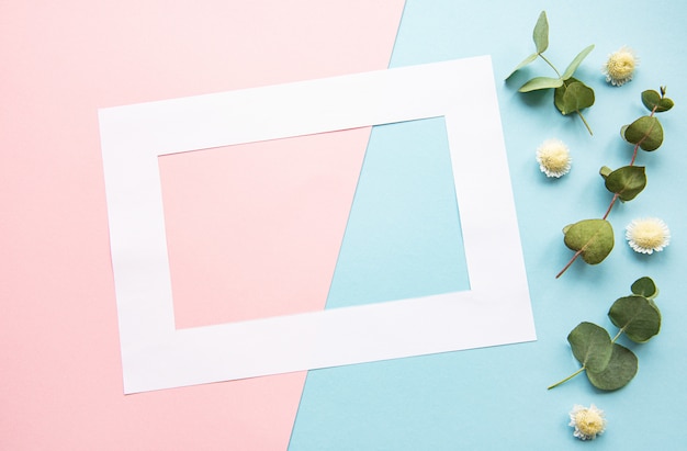 White frame and  flowers with eucalyptus leaves