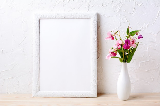 White frame mockup with pink flowers in elegant vase