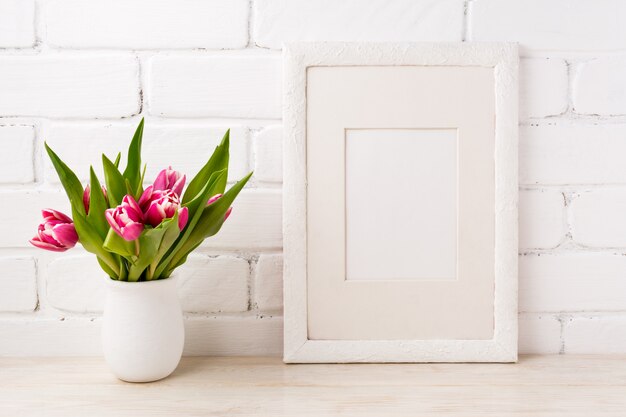 White frame with magenta pink tulip in the flower pot