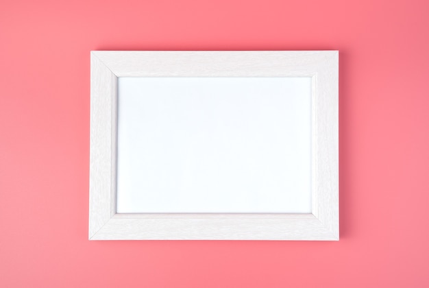 White frame with space to copy, on a pink background.