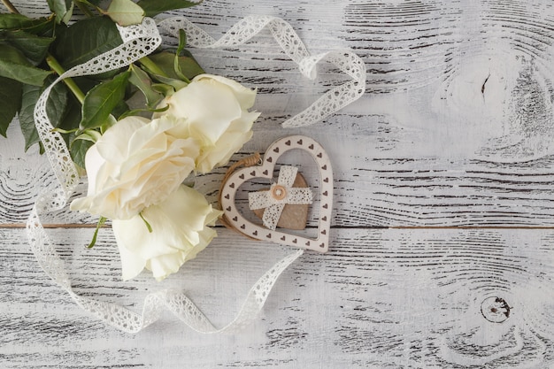 White fresh rose flowers on white lace background