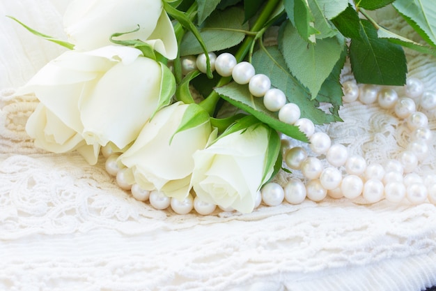 White fresh roses buds with lace and pearls jewelery