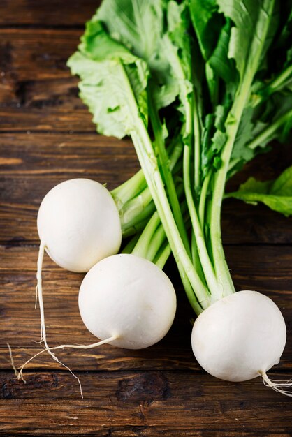 White fresh turnip on the wooden table