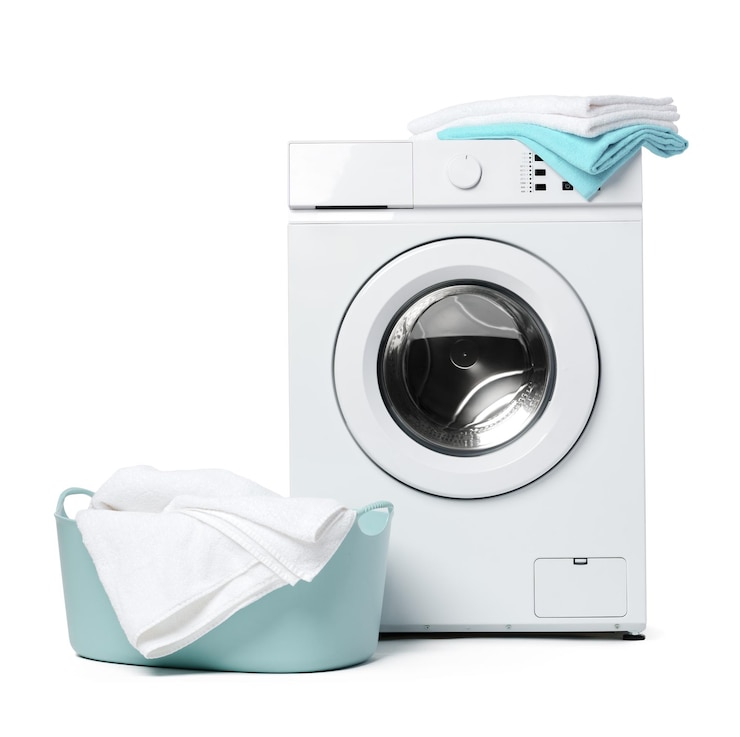 Photo white front load washing machine with laundry basket and clean clothes