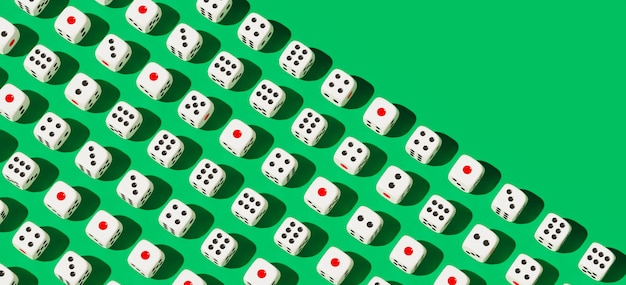 White gaming dices pattern on green background