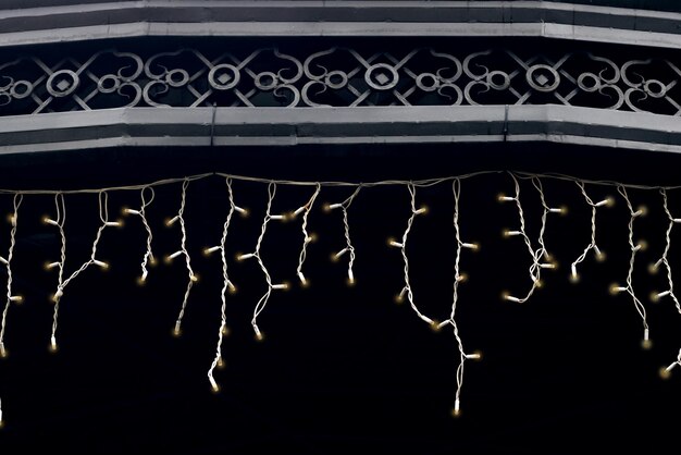 White garland hanging from the roof forged arbor