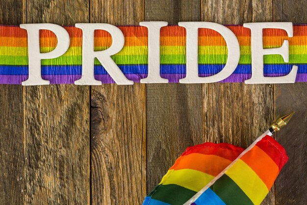 Photo white gay pride sign on wood background.