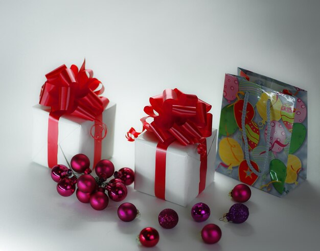 White gift box and christmas balls isolated on white background