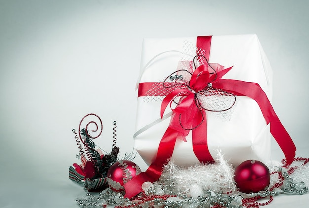 White gift box and Christmas decorations on a white background