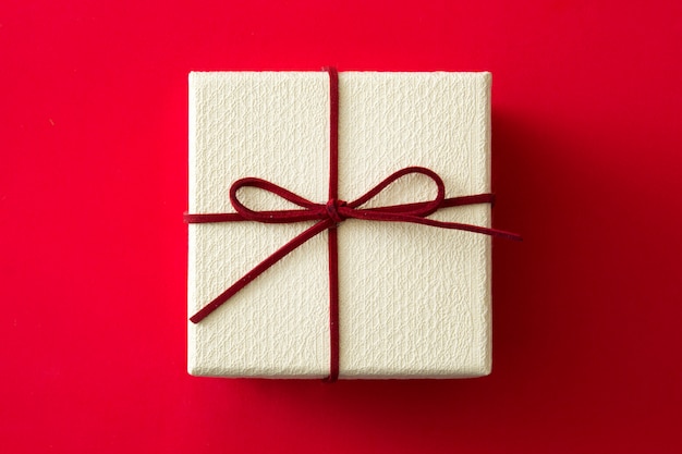 White gift box on red background