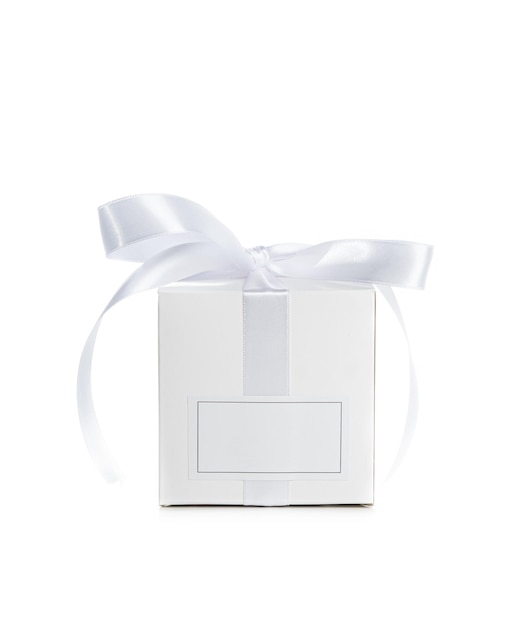 Photo white gift box with empty lable and satin ribbon isolated on white background holiday present package