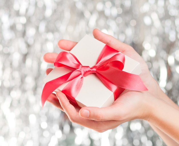 White gift box with red ribbon