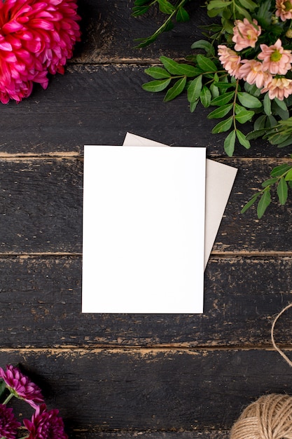 White gift card with beautiful flowers on a dark vintage table