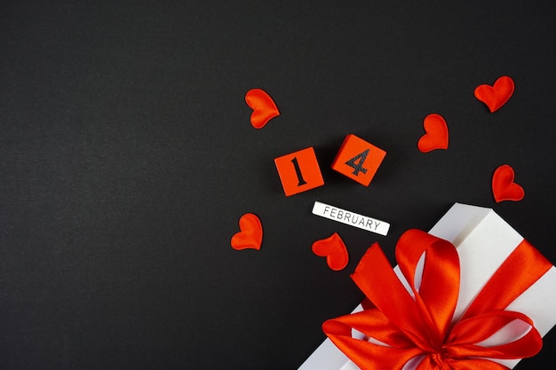 White gifts with red bows on February 12 are on a black background