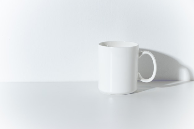 White glass coffee cup mug ceramic with wall room background table minimal