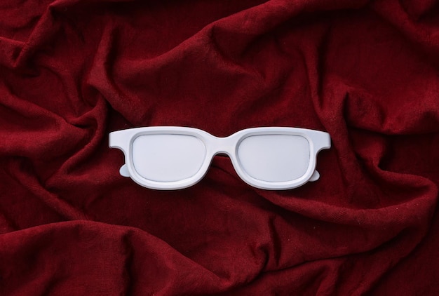 White glasses on a red silk background Minimalism