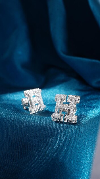 White Gold Diamond Earrings Isolated on blue background