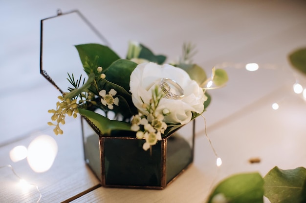 White gold wedding rings in a handmade glass box