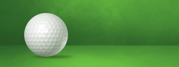 緑のスタジオバナーに分離された白いゴルフボール。