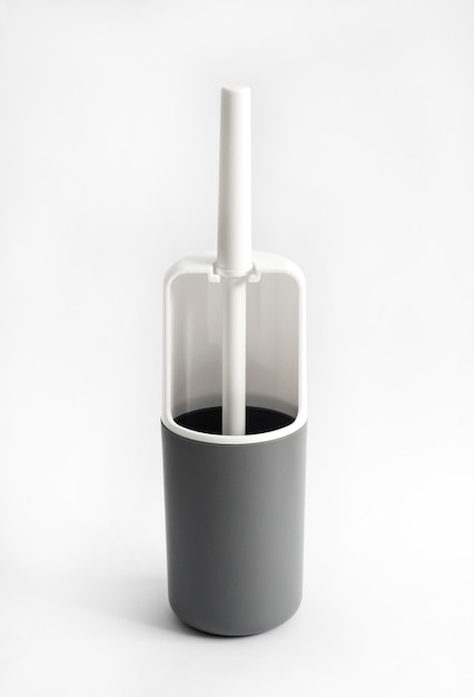 White and gray plastic toilet brush on white surface
