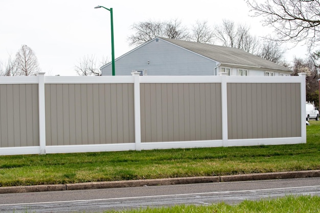 White and gray white vinyl fence close