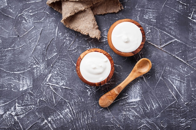 White greek yogurt in wooden bowl