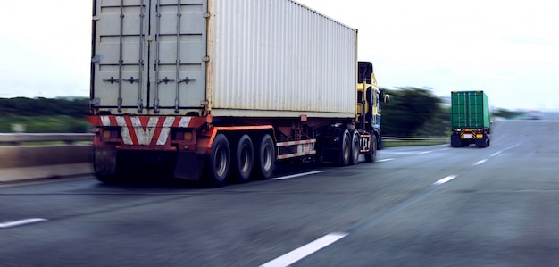 White and green container truck on highway ,transportation concept.,import,export logistic industrial Transporting Land transport on the asphalt expressway