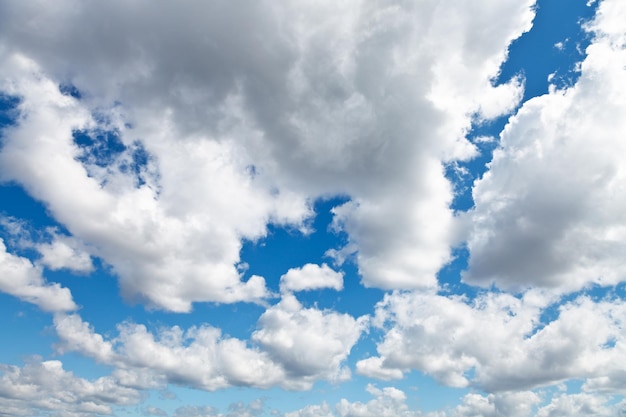 White and grey woolpack clouds in blue sky