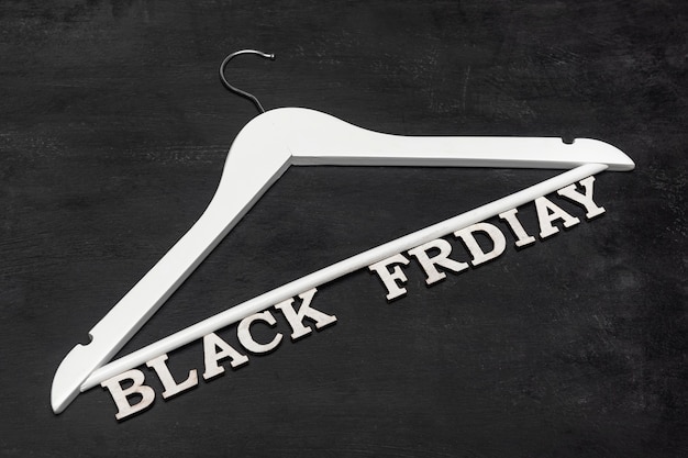 White hanger and inscription Black friday. Special offer. Black background. Discounts. Seasonal sale.