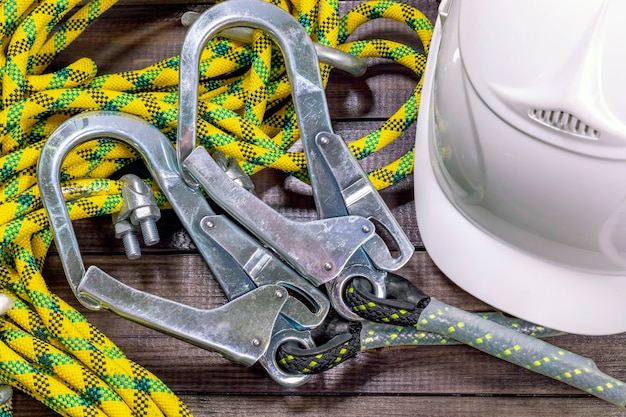 White hardhat and carabines with yellow ropes