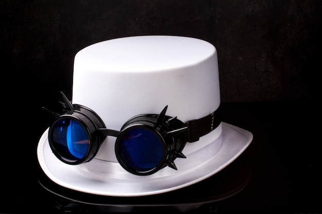 white hat with steampunk black glasses