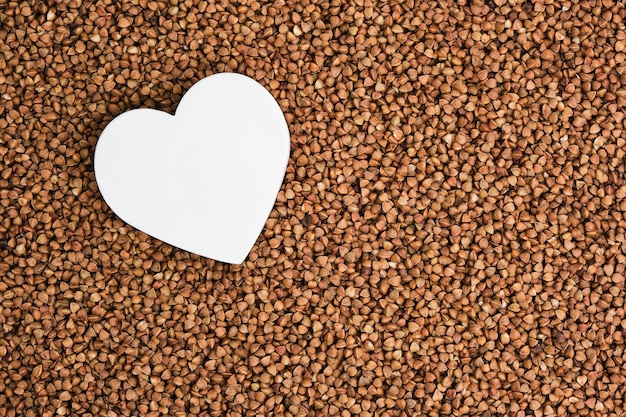 Photo white heart on the background buckwheat