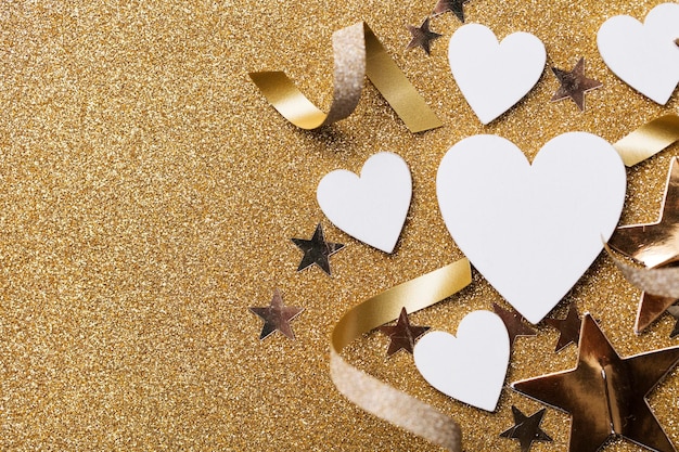 White heart shape on a golden glitter backgrond