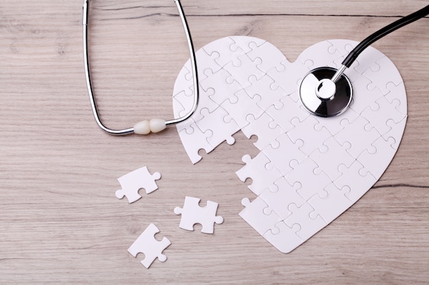 White heart shape puzzle with stethoscope