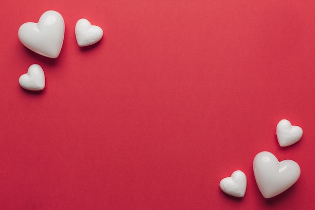 white hearts on a red background with copyspace