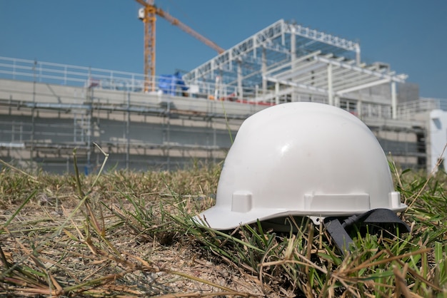 white helmet on nature grass construction site background