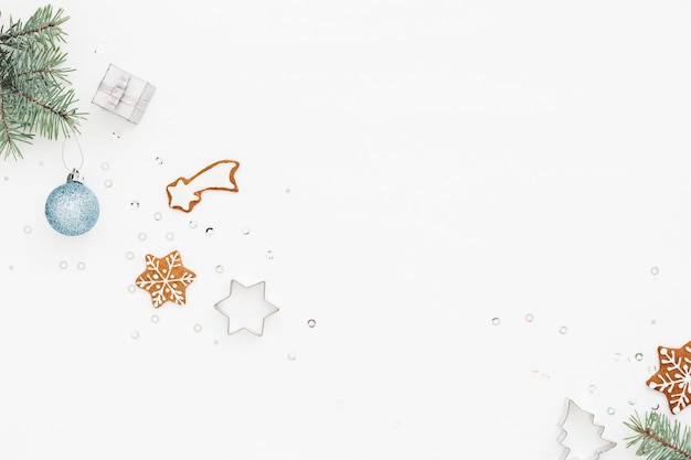 White holiday background with gingerbread and Christmas decorations