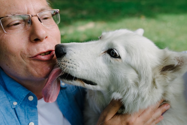 White husky kisses her master