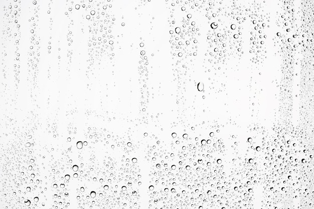 white isolated background water drops on the glass / wet window glass with splashes and drops of water and lime, texture autumn background