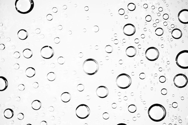 white isolated background water drops on the glass / wet window glass with splashes and drops of water and lime, texture autumn background