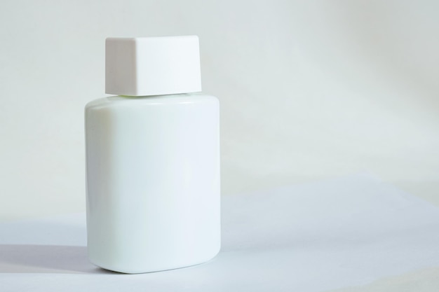 White jar with body care product on a white background