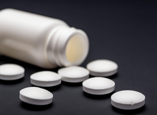 White jar with watered pills on black background