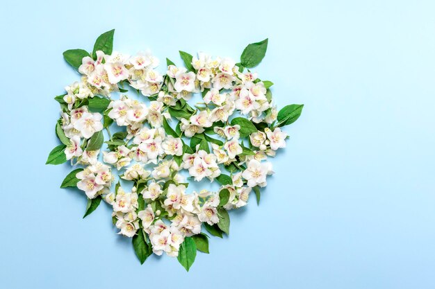 White jasmine flowers in the shape of a heartFloral greeting card For the wedding birthday or other celebration