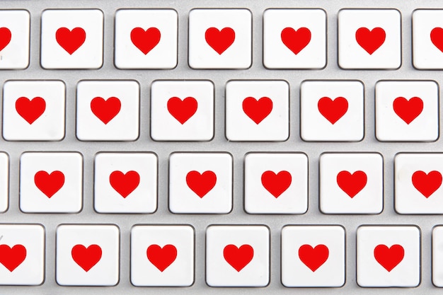 White keyboard with an icon of red heart on the buttons