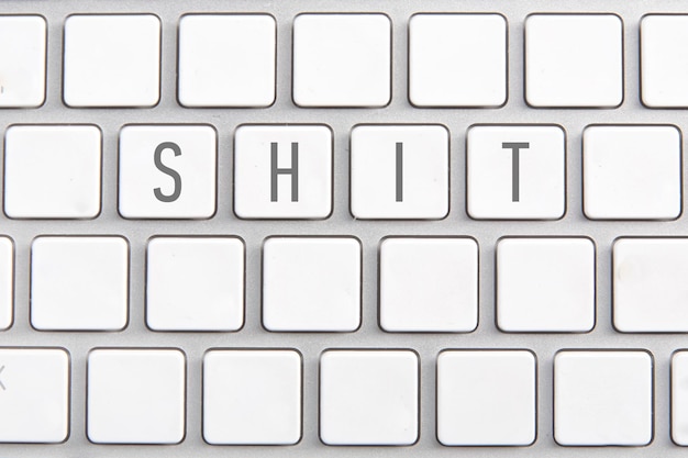 White keyboard with an inscription on the buttons Shit